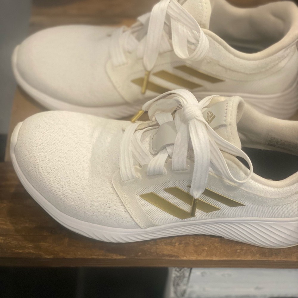 Addidas sneakers, size 6, white with gold stripes and gold at end of laces.